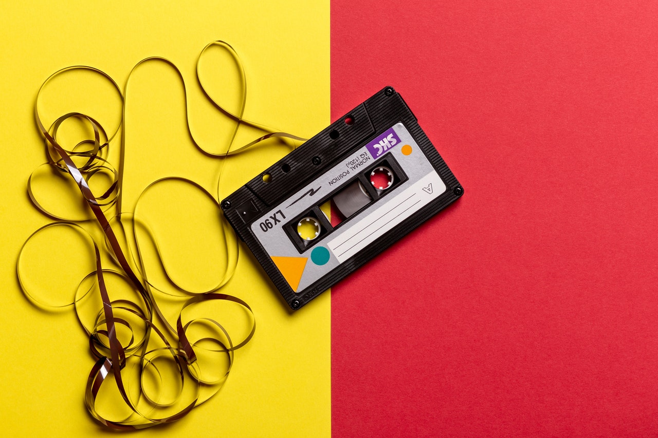 A cassette on a yellow and red background.